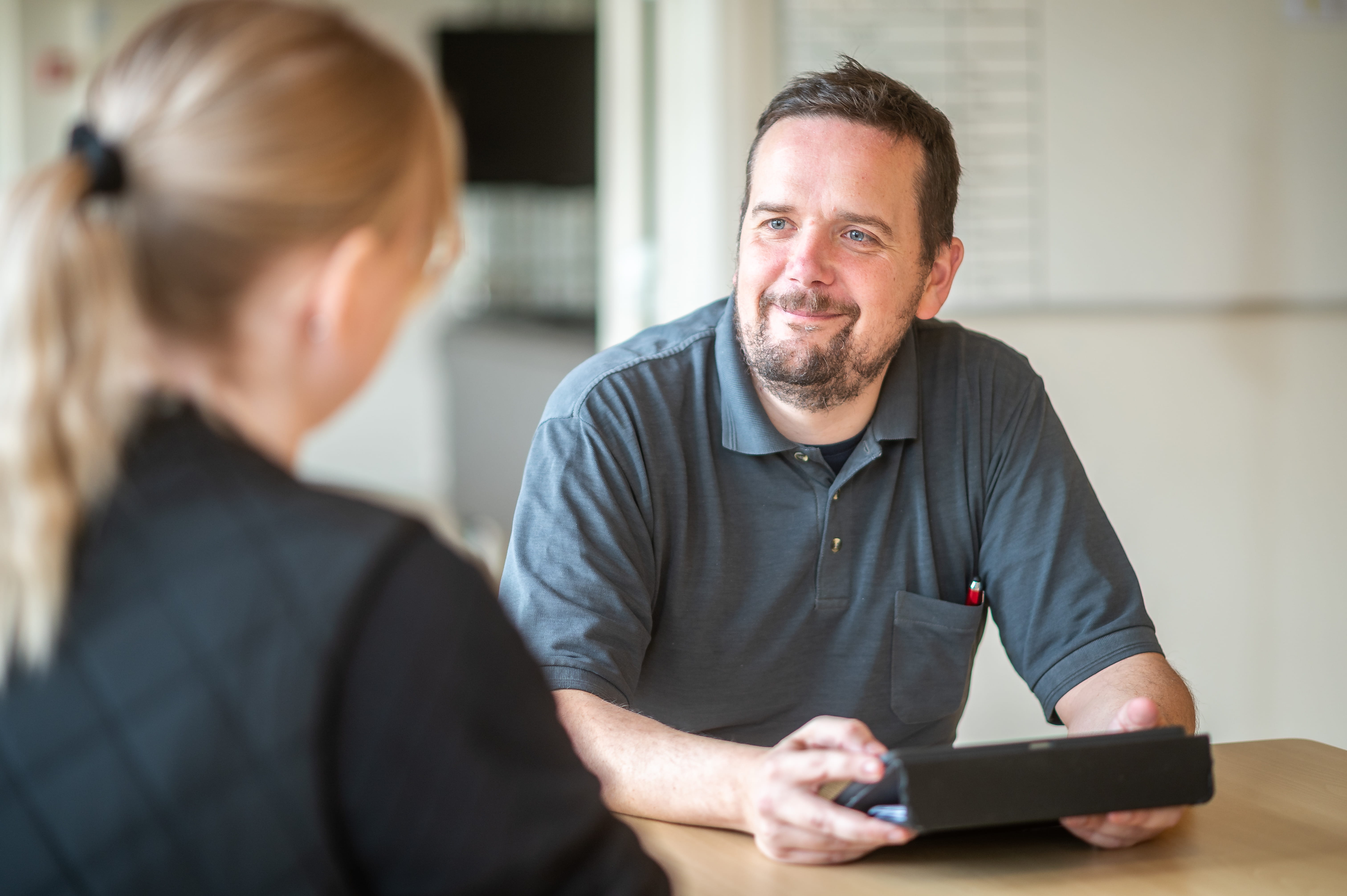 Kim fra Botilbuddet Rydsåvej sidder med en iPad og holder sparring med en kollega.